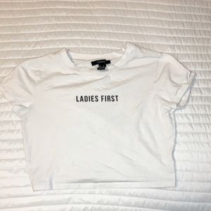 white woman crop top with black words on it